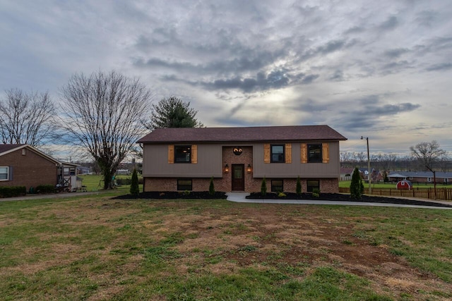 raised ranch with a front lawn