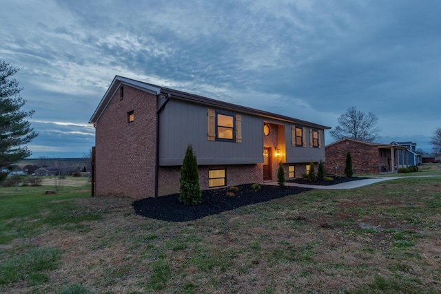 raised ranch with a front yard