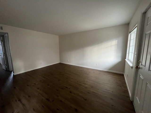 empty room featuring dark hardwood / wood-style flooring