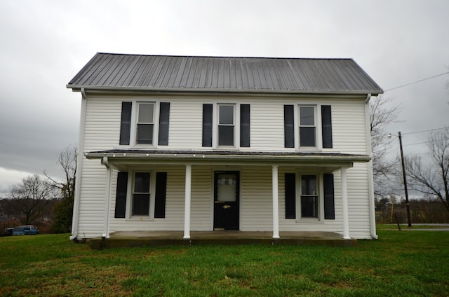 view of front of home with a porch and a front yard