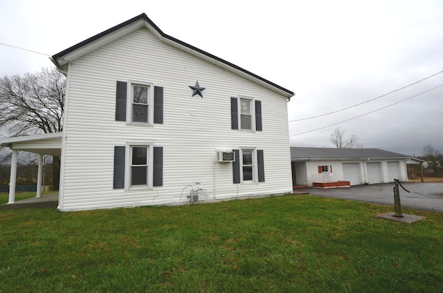 view of front facade featuring a wall mounted air conditioner and a front yard