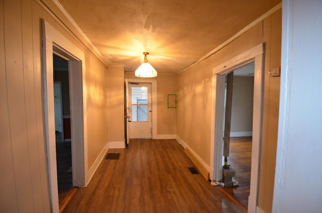 doorway featuring crown molding and dark wood-type flooring