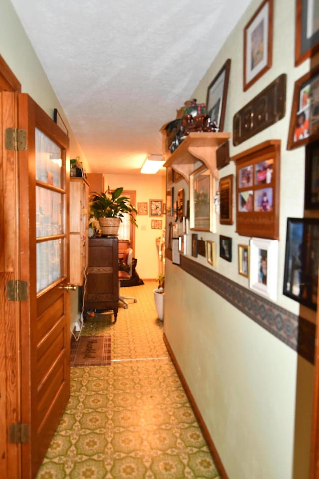 hallway featuring a textured ceiling