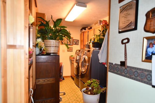 laundry room with washer and dryer and cabinets