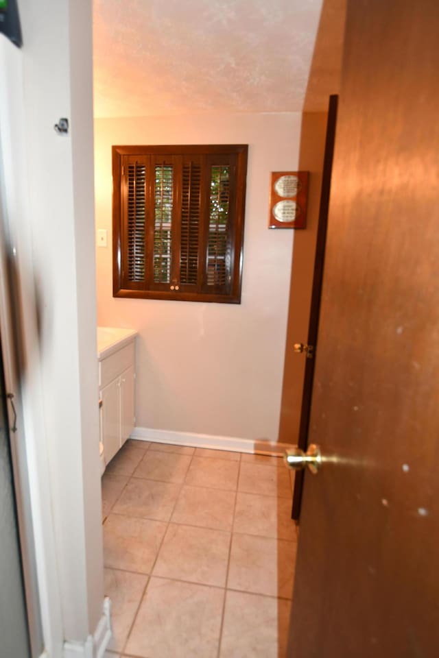 interior space with vanity and tile patterned flooring