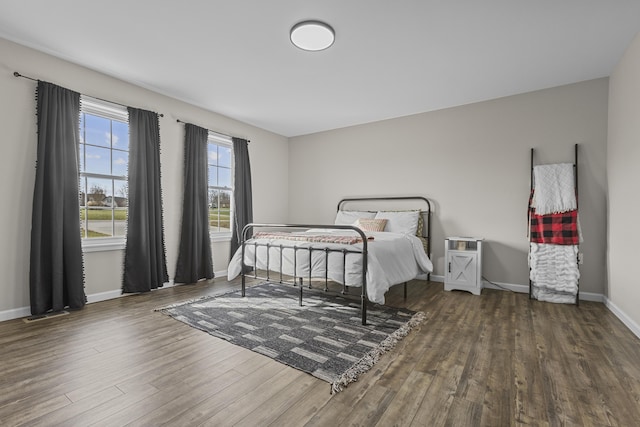 bedroom with dark hardwood / wood-style floors