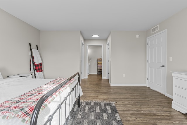 bedroom with dark hardwood / wood-style floors