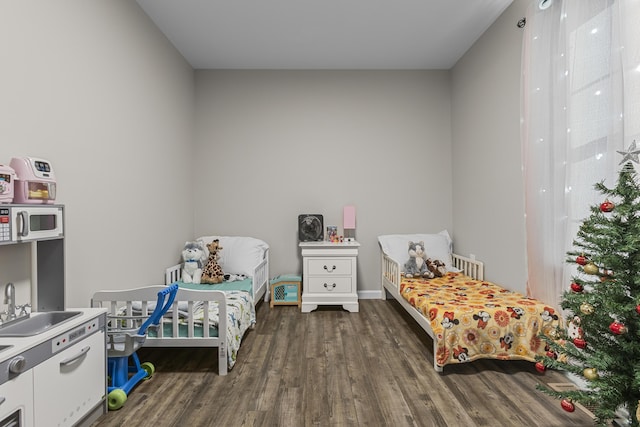 bedroom featuring dark hardwood / wood-style floors and sink