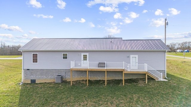 back of property with central AC unit, a deck, and a yard