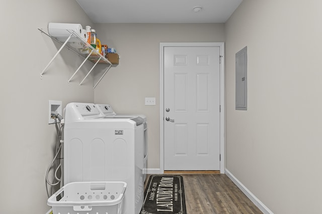 clothes washing area featuring washer and clothes dryer, dark wood-type flooring, and electric panel