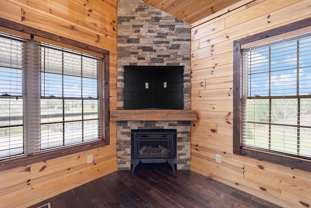 living room with wood walls and a healthy amount of sunlight