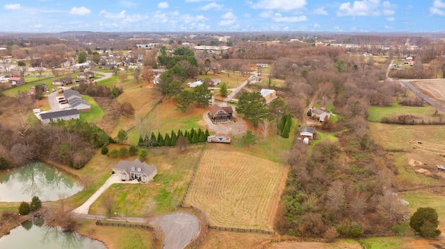 birds eye view of property with a water view and a rural view