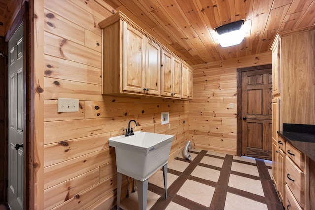 clothes washing area featuring wooden walls, cabinets, wooden ceiling, and hookup for a washing machine