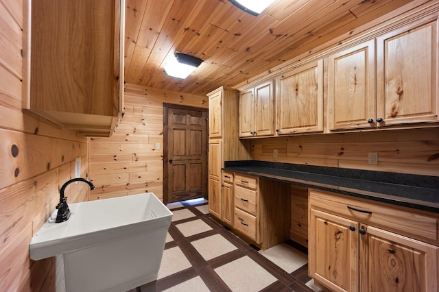 laundry area featuring sink, wood ceiling, and wood walls