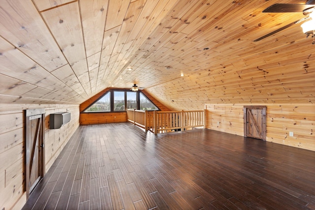 additional living space featuring dark hardwood / wood-style floors, wood walls, wood ceiling, and lofted ceiling