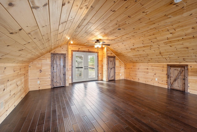 additional living space featuring lofted ceiling, dark hardwood / wood-style floors, wood walls, and wood ceiling