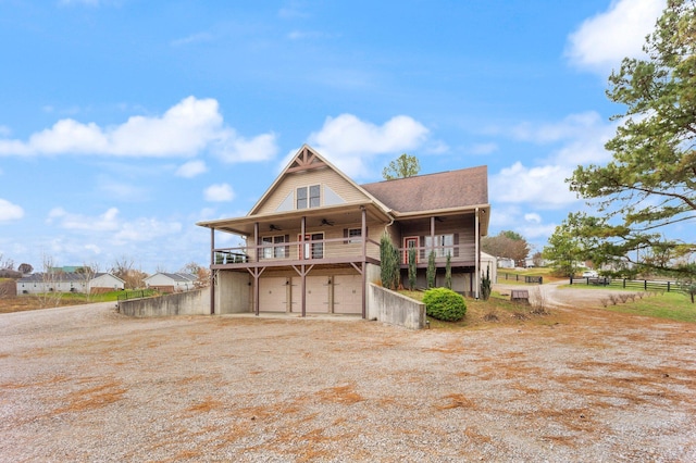 back of house featuring ceiling fan and a garage