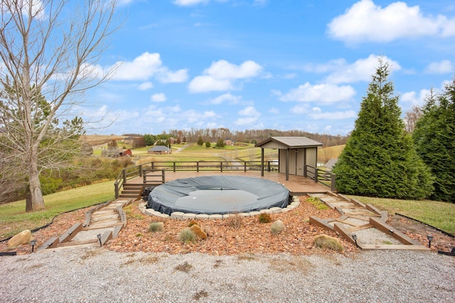 view of yard with a rural view and a shed