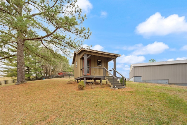 rear view of house with a yard