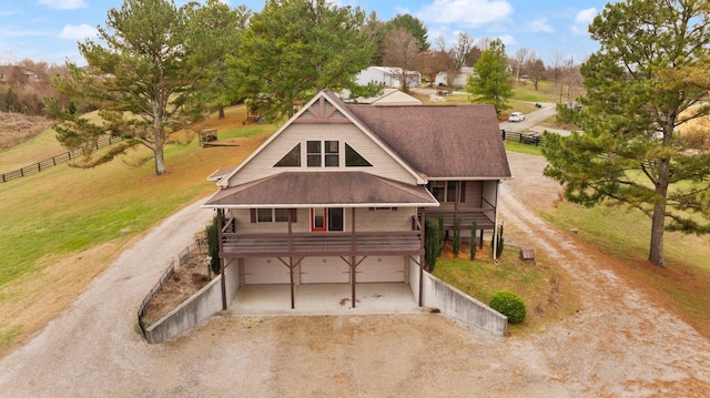 view of front of house featuring a porch and a garage