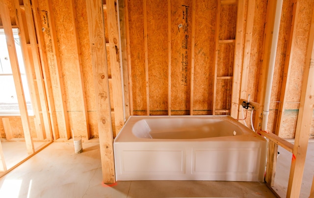 bathroom with a tub to relax in