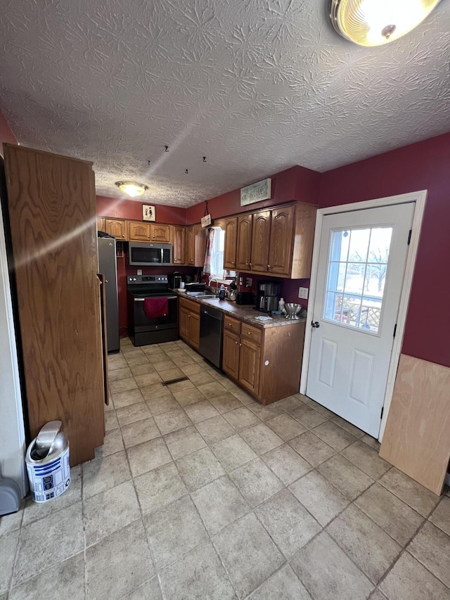 kitchen with sink, black appliances, and a textured ceiling