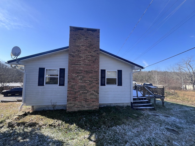 view of side of home featuring a wooden deck