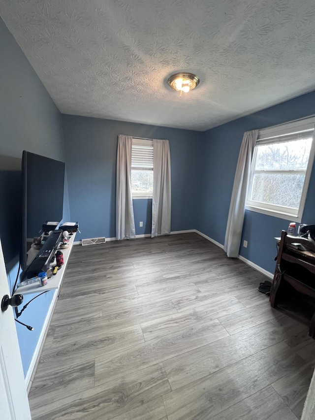 office area featuring a textured ceiling and light wood-type flooring