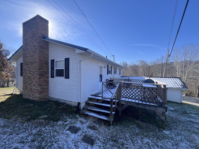 rear view of property featuring a deck