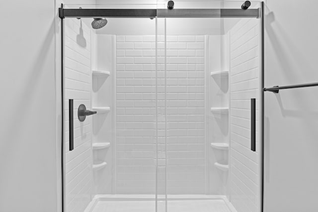 bathroom with a shower with shower door