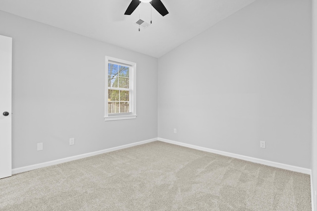 carpeted empty room with vaulted ceiling and ceiling fan