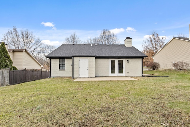 back of house with a yard and a patio