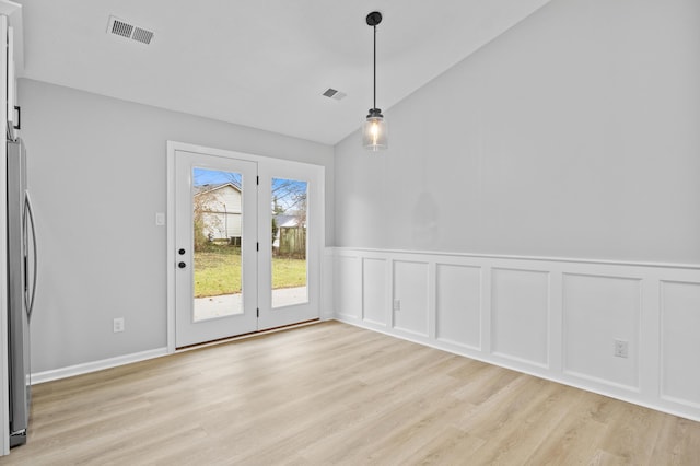 interior space with light hardwood / wood-style flooring and vaulted ceiling