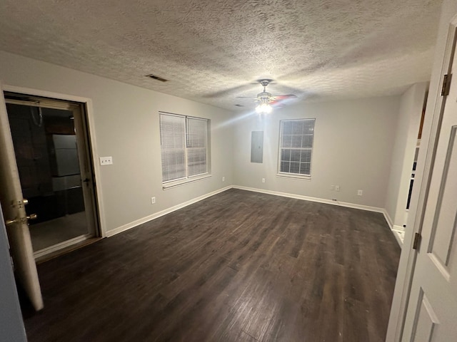 unfurnished bedroom featuring electric panel, ceiling fan, dark hardwood / wood-style floors, and a textured ceiling