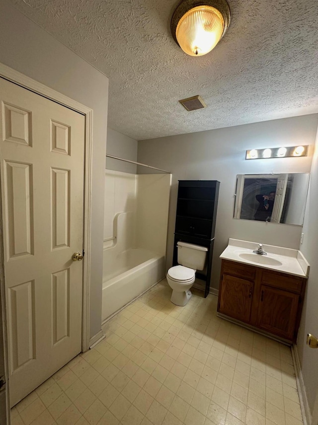 full bathroom featuring vanity, shower / bath combination, a textured ceiling, and toilet