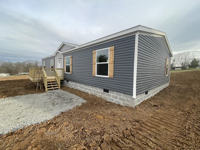 view of side of property featuring a wooden deck