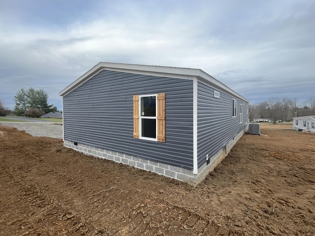 view of side of home with central air condition unit