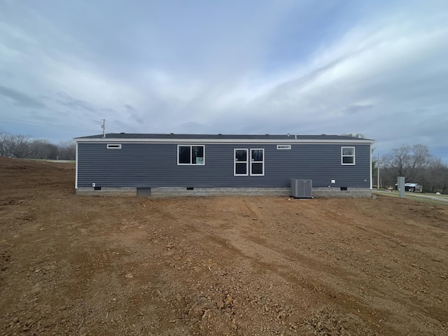 back of house with central air condition unit