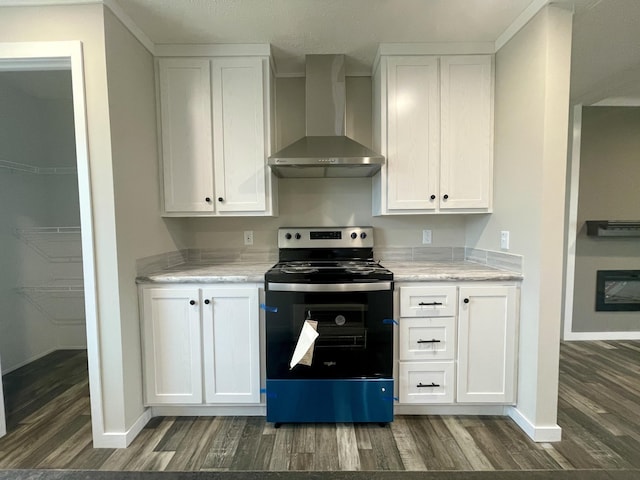 kitchen featuring dark wood-type flooring, light stone counters, white cabinets, stainless steel electric range oven, and wall chimney exhaust hood