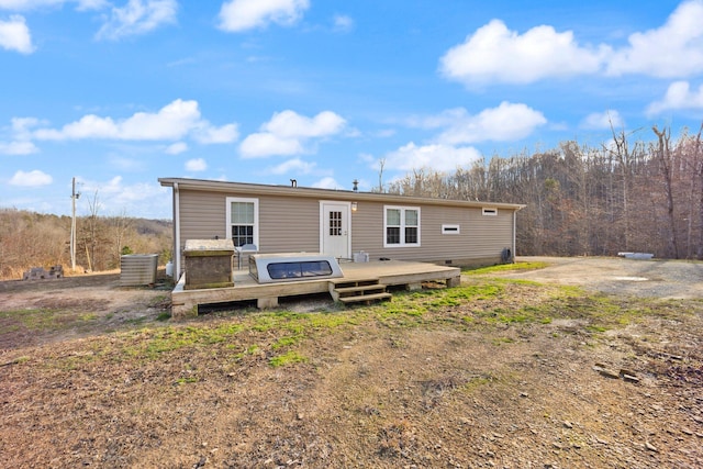 rear view of property with a wooden deck