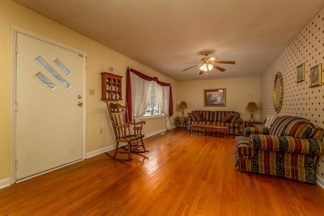 living room featuring wood-type flooring and ceiling fan