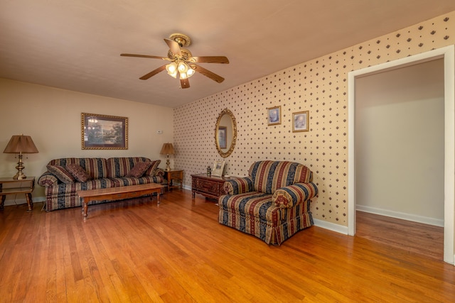 living room with ceiling fan and light wood-type flooring