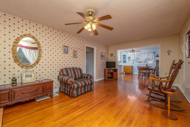 sitting room featuring ceiling fan and light hardwood / wood-style flooring