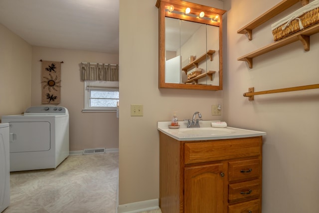 bathroom with vanity and independent washer and dryer