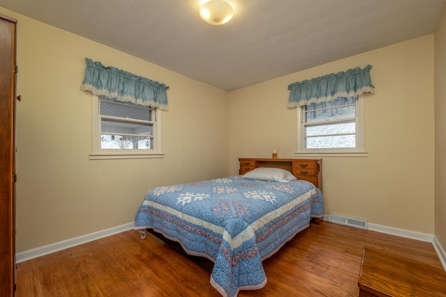 bedroom with hardwood / wood-style flooring