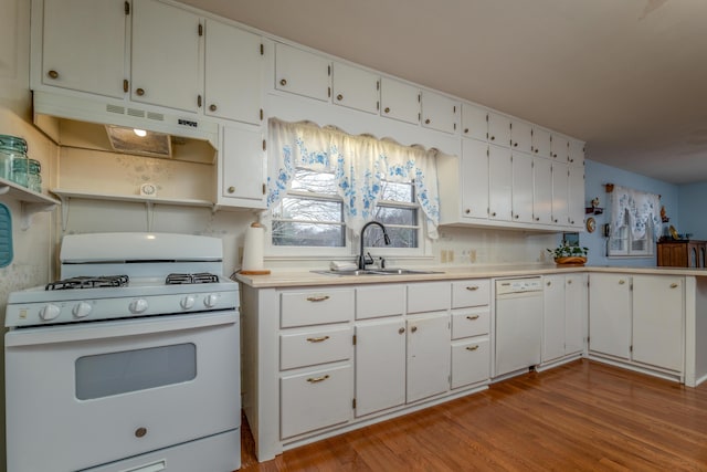 kitchen featuring sink, white cabinets, white appliances, and light wood-type flooring