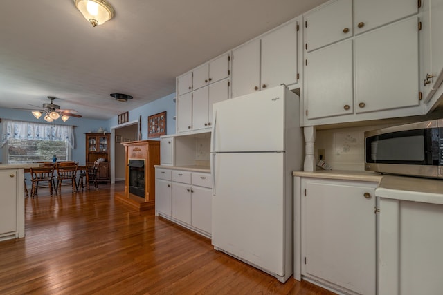 kitchen featuring white cabinets, white fridge, light hardwood / wood-style flooring, and ceiling fan