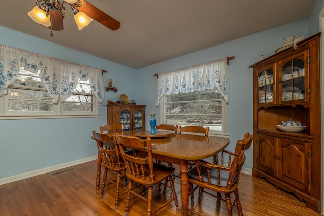 dining area featuring hardwood / wood-style floors and ceiling fan