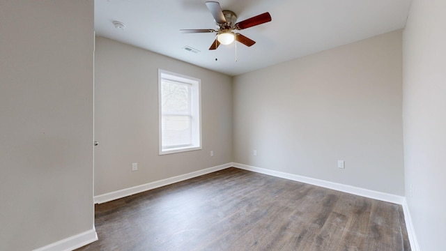 empty room featuring ceiling fan and dark hardwood / wood-style flooring