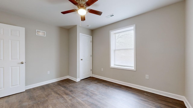 unfurnished bedroom with ceiling fan and dark hardwood / wood-style floors